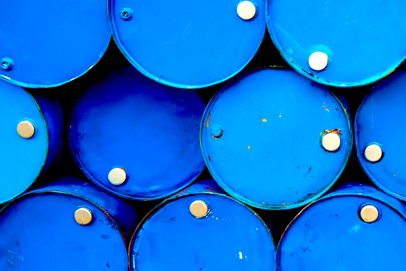 Blue oil barrels stacked on top of one another