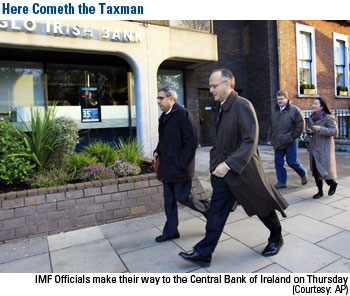 Here Comes the Taxman! IMF officials make their way to the Central Bank of Ireland on Thursday.